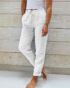 White relaxed drawstring casual pants with pockets and gathered ankle cuffs