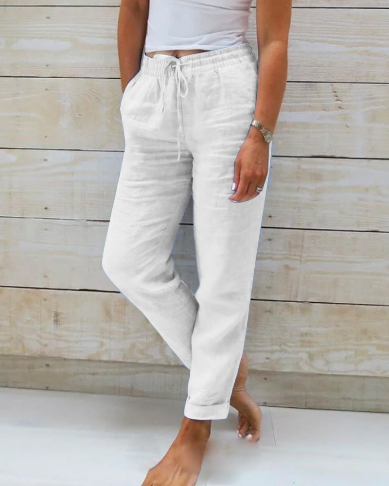 White relaxed drawstring casual pants with pockets and gathered ankle cuffs