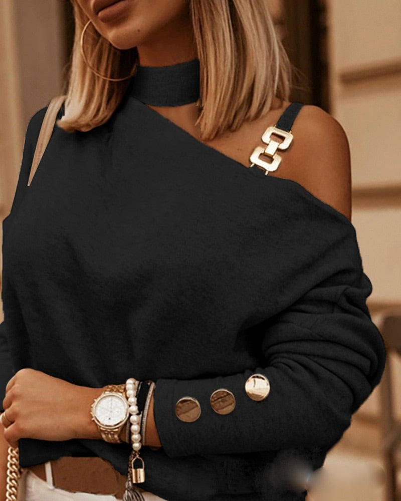 Black one-shoulder sweater with round buttons on cuffs and layered neckline
