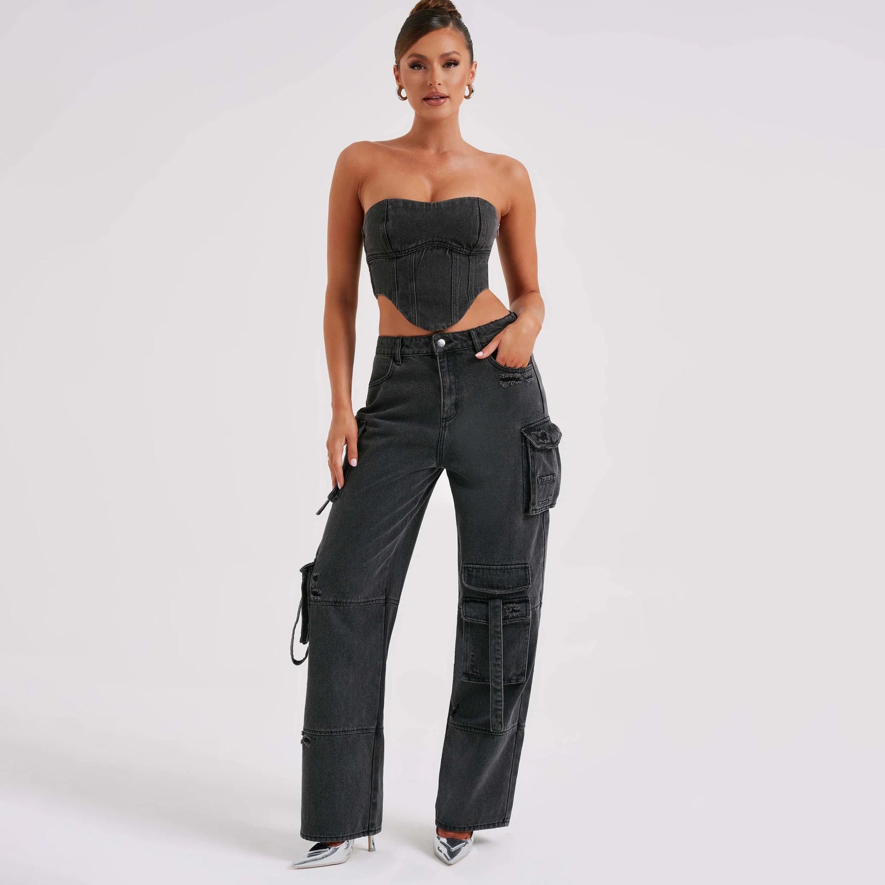 Black high-waist cargo jeans with relaxed fit and utility pockets, tie details.