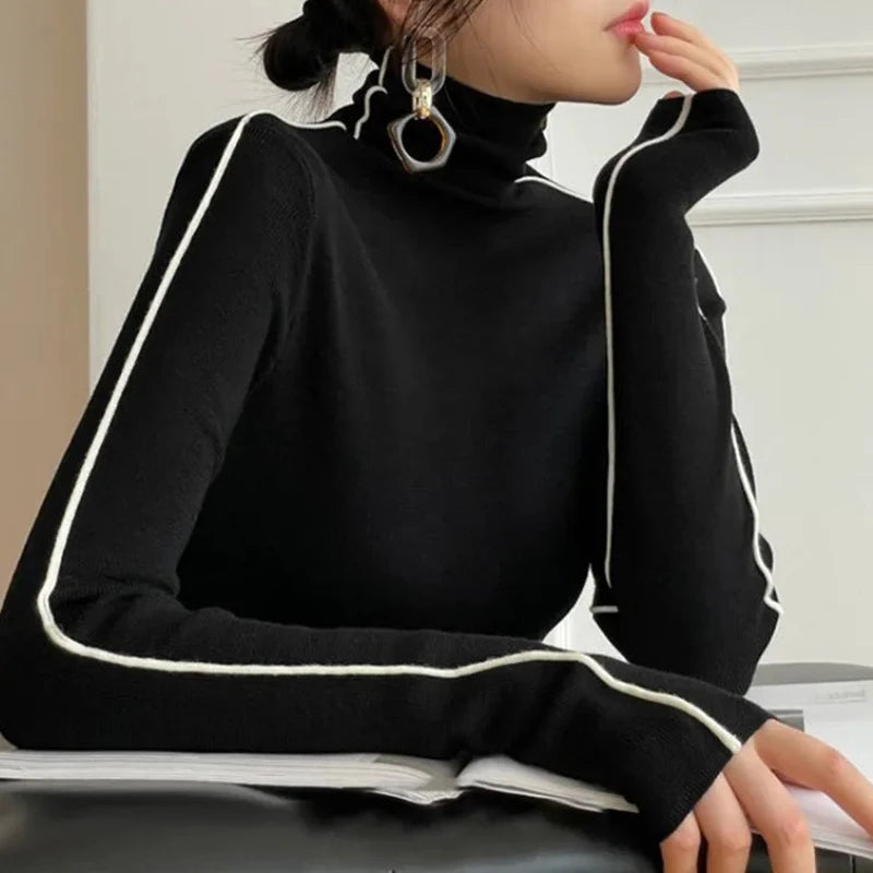 Black turtleneck sweater with contrasting white trim and long sleeves