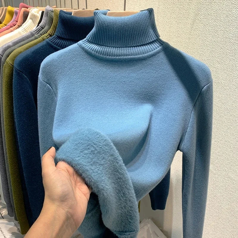Light blue turtleneck velvet sweater with ribbed collar and fuzzy sleeve cuff