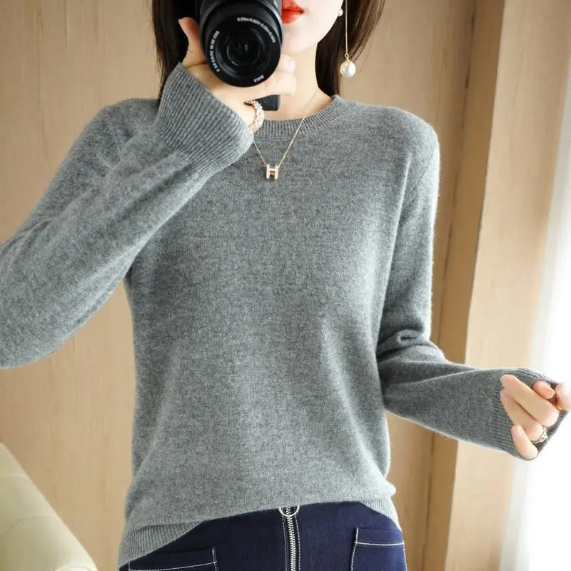 Gray crewneck pullover sweater with long sleeves and ribbed cuffs and hem