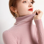 Soft pink ribbed turtleneck sweater with long sleeves and close neckline