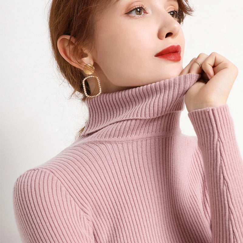 Soft pink ribbed turtleneck sweater with long sleeves and close neckline