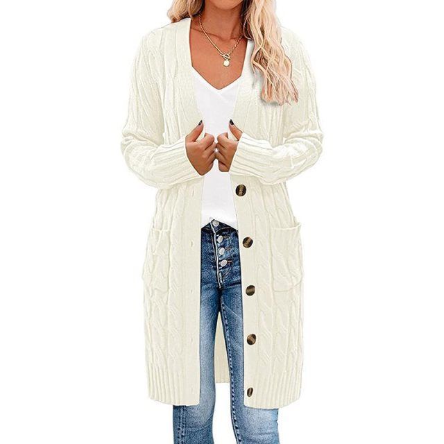 Off-white long knitted vest with button-front, cable texture, and side pockets.