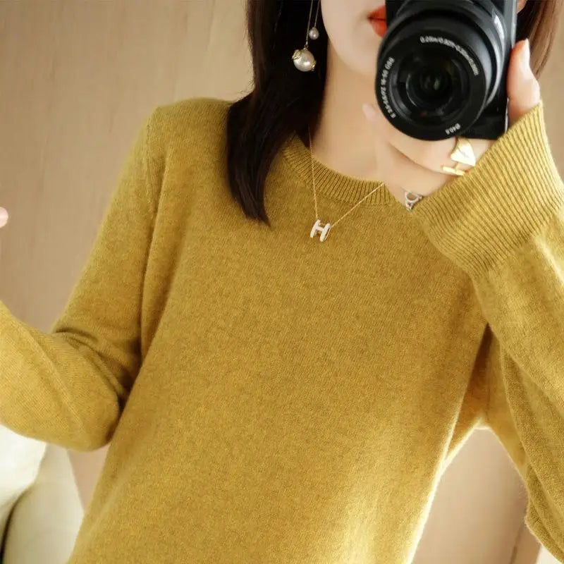 Mustard yellow crewneck pullover sweater with long sleeves and ribbed cuffs and hem