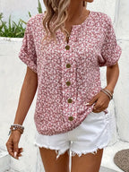 Pink floral short-sleeve button-up blouse with front button placket