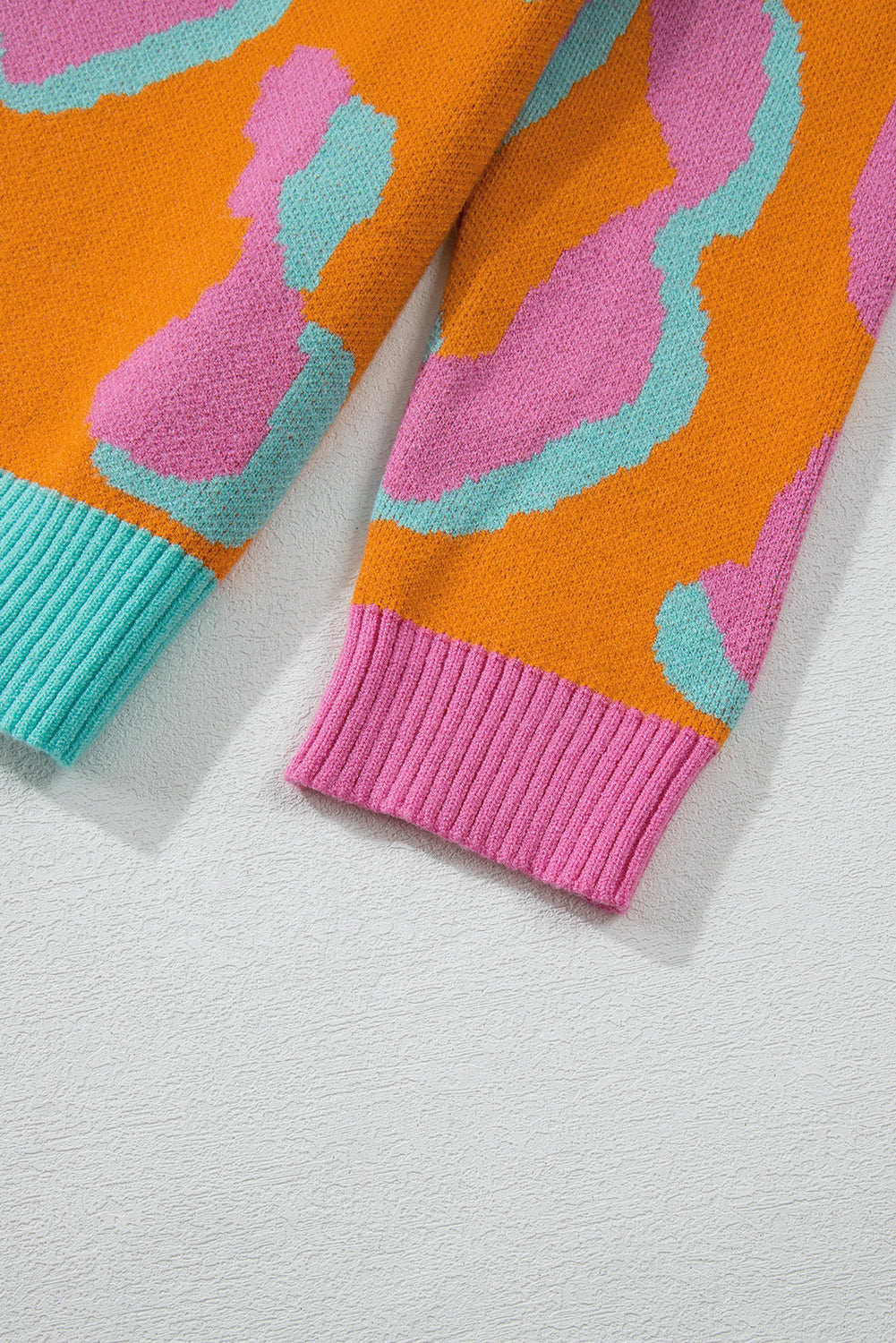 Women’s colorblock leopard print sweater, orange with teal and pink ribbed cuffs