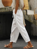 Women's white loose cotton drawstring pants with side pockets, cropped leg