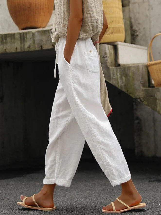 Women's white loose cotton drawstring pants with side pockets, cropped leg