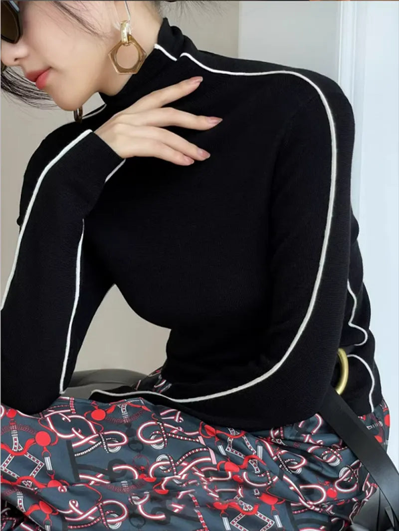 Black turtleneck sweater with white contrast piping and long sleeves
