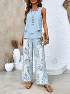 Light blue layered sleeveless blouse with wide-leg trousers in blue leaf print