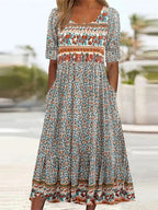 Boho print midi dress with short sleeves, square yoke, and tiered skirt hem detail