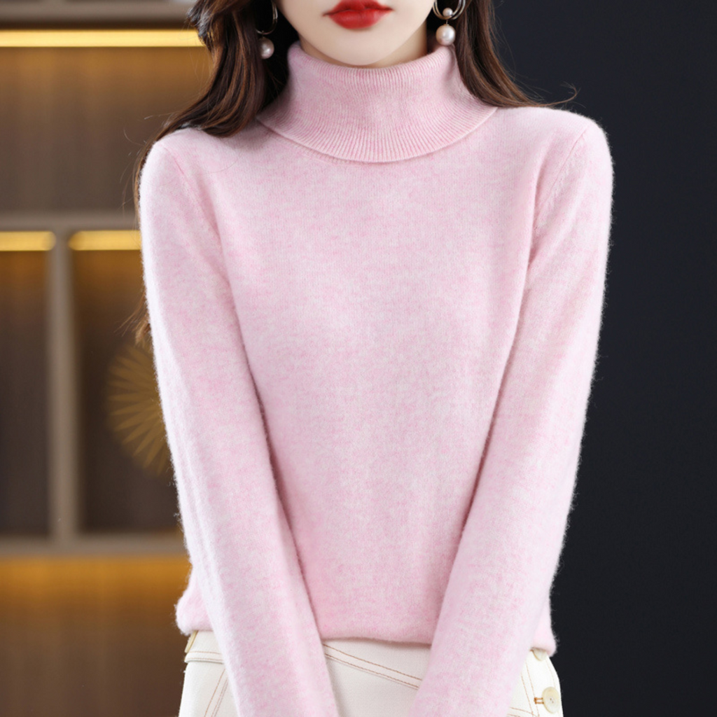 Women's cashmere turtleneck sweater in light pink, long sleeves, ribbed collar and cuffs.