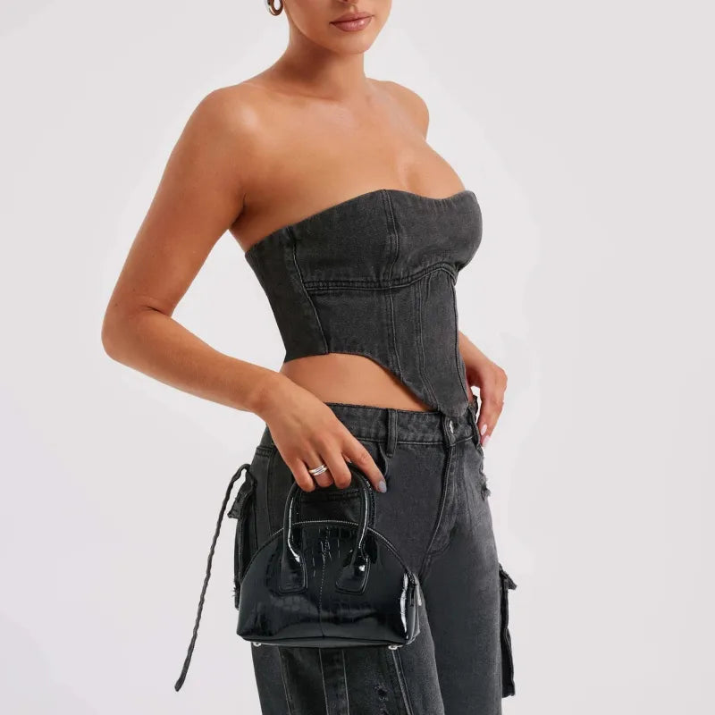 Black denim cargo jeans, high waist with utility pockets and button front closure.