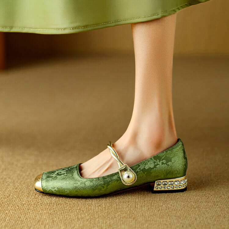 Green Mary Jane flat shoes with twisted strap, pearl button detail, and decorative block heel