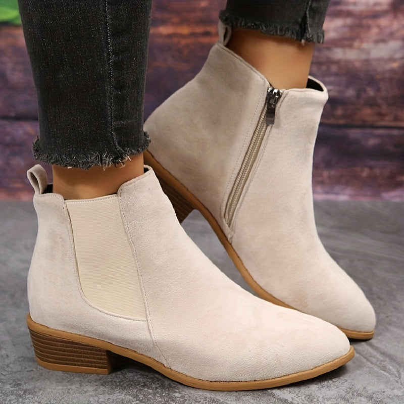 Off-white suede ankle boots with elastic side panels and low stacked heel