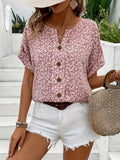 Pink floral short-sleeve button-up blouse worn with white frayed denim shorts