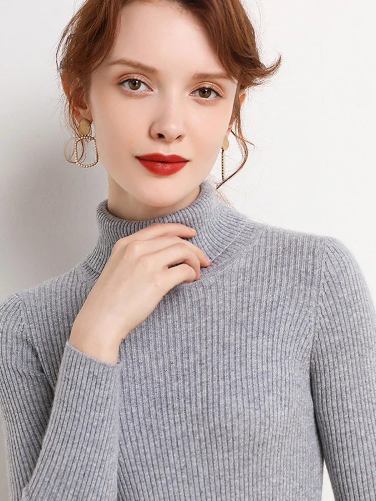Gray ribbed turtleneck sweater worn by a model with long sleeves