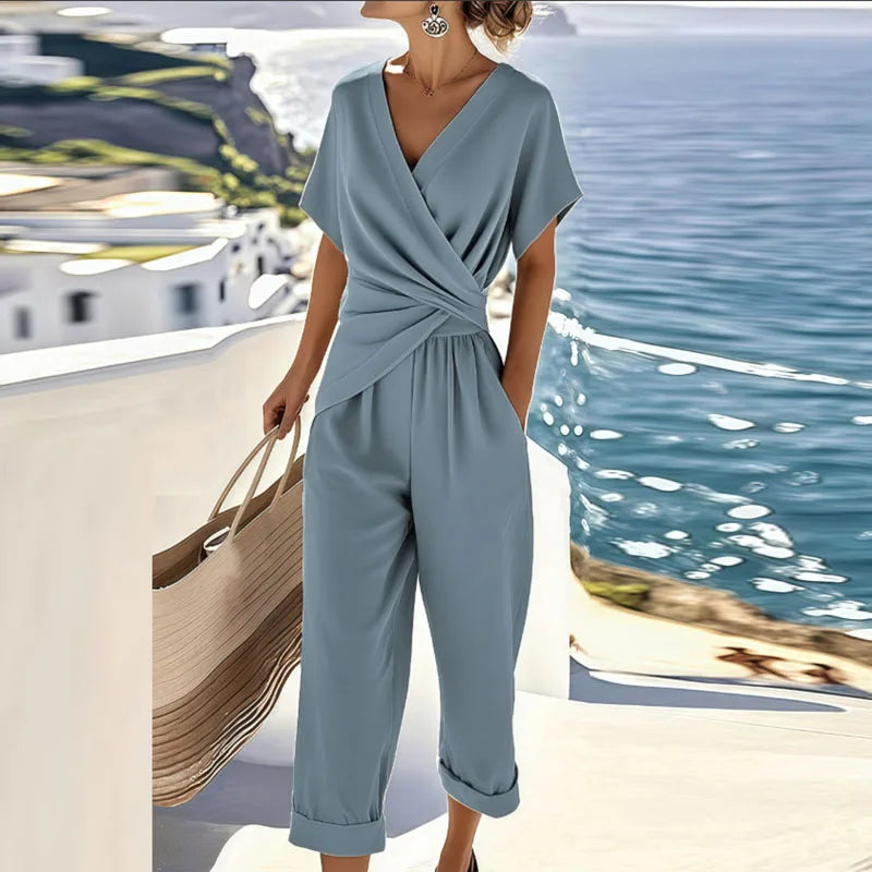 Women’s blue V-neck jumpsuit with short sleeves, wrap front tie waist, wide cropped pant legs