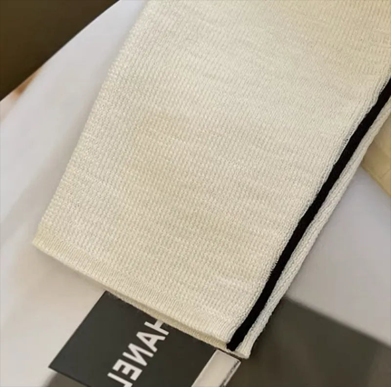 Cream turtleneck fabric with black trim along the side seam