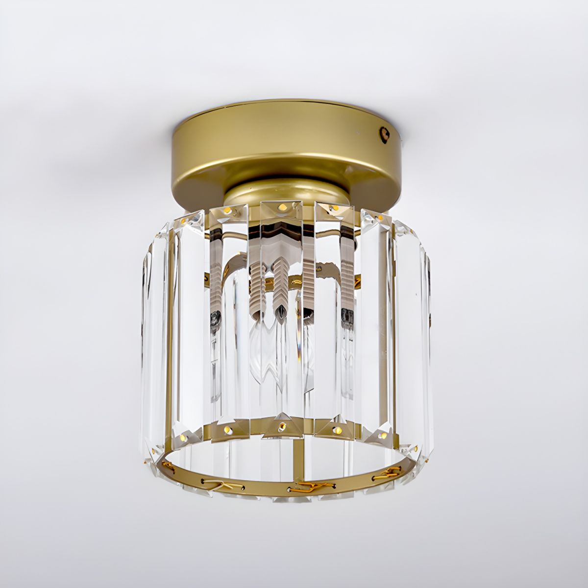 Gold crystal flush mount ceiling lamp with clear crystal shade and round brass rim