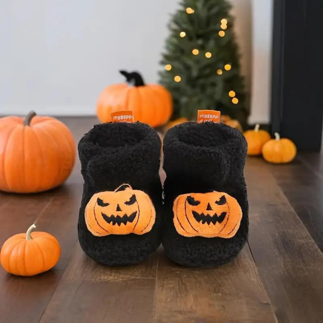 Children's Halloween slippers in black with orange jack-o'-lantern cartoon patches