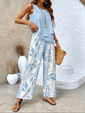 Light blue sleeveless blouse with tiered hem and wide-leg trousers in blue leaf print