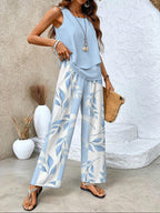Light blue sleeveless blouse with tiered hem and wide-leg trousers in blue leaf print