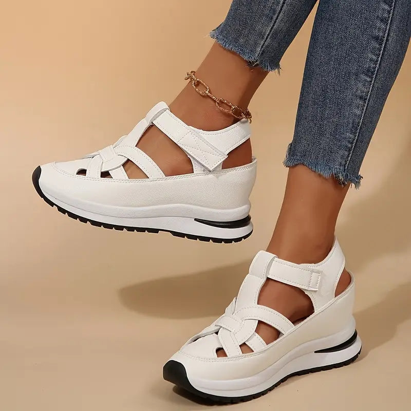 White platform sandals with crisscross straps and cushioned sole, side view