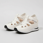 White platform sandals with cross straps and cushioned sole, front view