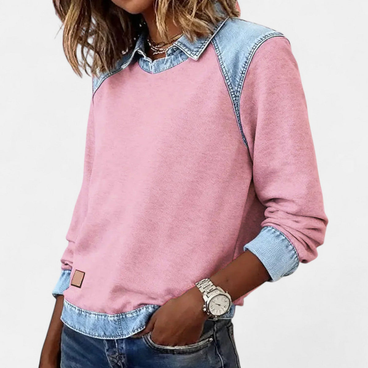 Women's pink sweater with layered denim collar, shoulders, cuffs, and hem.