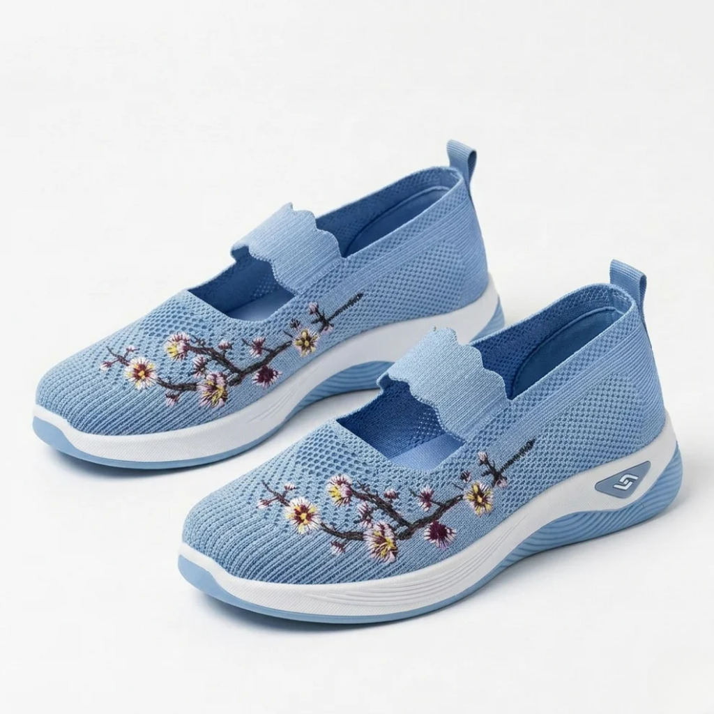 Light blue knit slip-on sneakers with floral embroidery and cushioned white sole