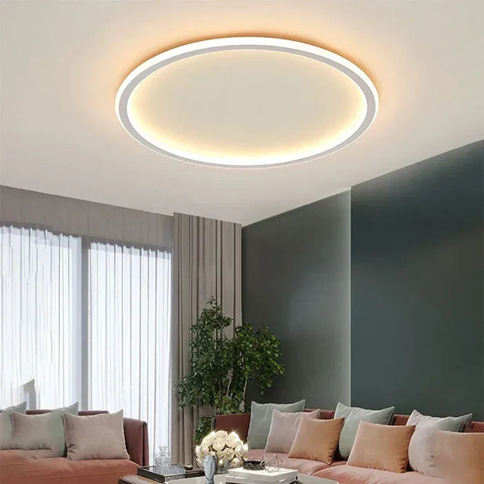 Round LED flush mount ceiling light with white outer ring and warm glowing halo
