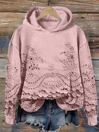 Pink floral-embroidered hoodie with scalloped lace hem.
