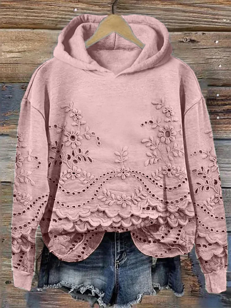Pink floral-embroidered hoodie with scalloped lace hem.