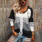 Striped women's sweater in black and cream with white lace-up front placket.