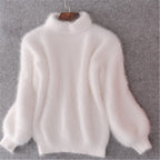 White loose knit wool sweater with high neck and long voluminous sleeves