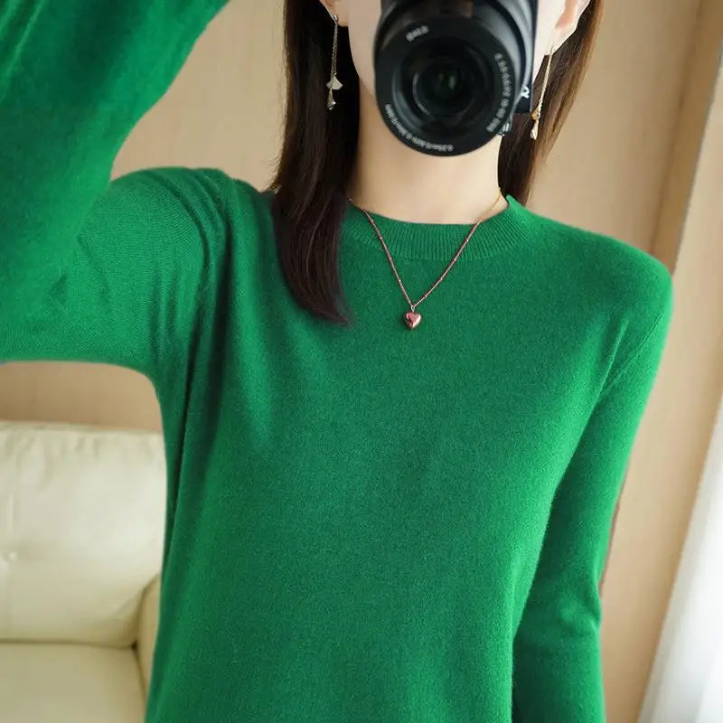 Green crewneck pullover sweater with long sleeves and ribbed cuffs and hem