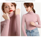 Light pink ribbed turtleneck sweater with long sleeves and close fit