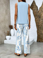 Light blue sleeveless blouse and wide-leg trousers with white-and-blue leaf print