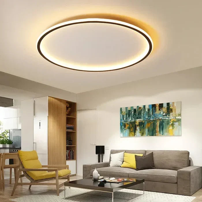 Round LED flush mount ceiling light with dark outer ring and warm glowing halo