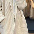 Women’s cream open-front knit cardigan showing patch pocket and ribbed cuffs