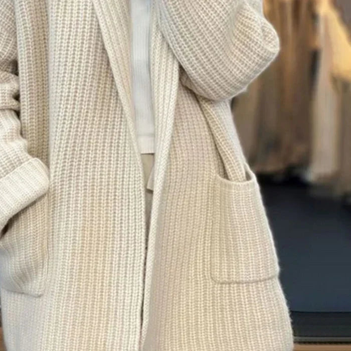 Women’s cream open-front knit cardigan showing patch pocket and ribbed cuffs
