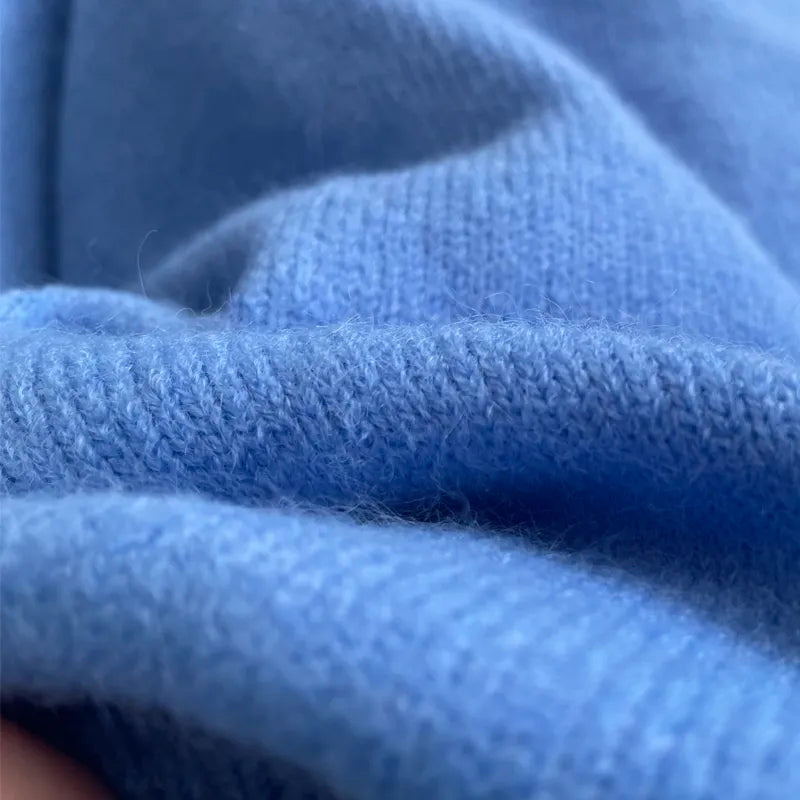 Light blue cashmere knit close-up with ribbed cuff texture.