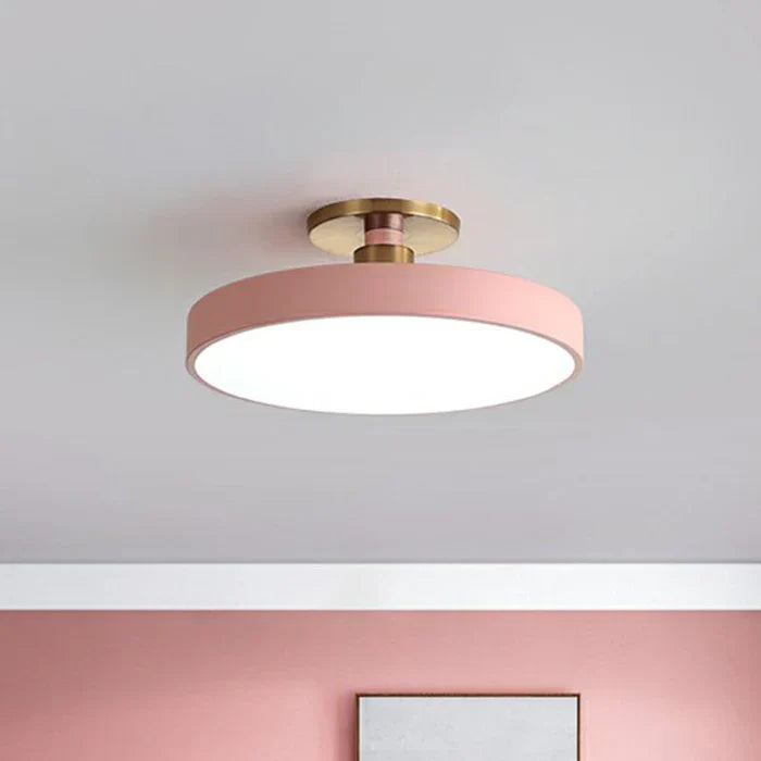 Round flush-mount LED ceiling lamp, pink shade with gold base and white light