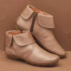 Women’s vintage-style ankle boots, light beige with contrast tan stitching and side zipper.