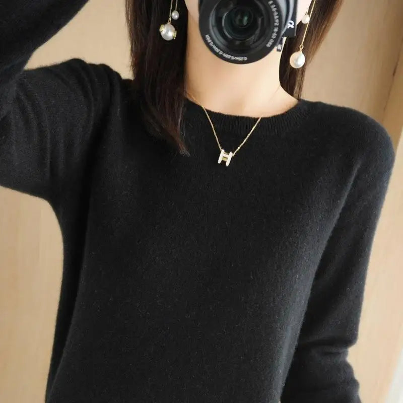 Black crewneck pullover sweater with long sleeves and ribbed cuffs and hem
