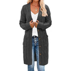 Dark gray long knitted vest with button-front and cable texture side pockets.